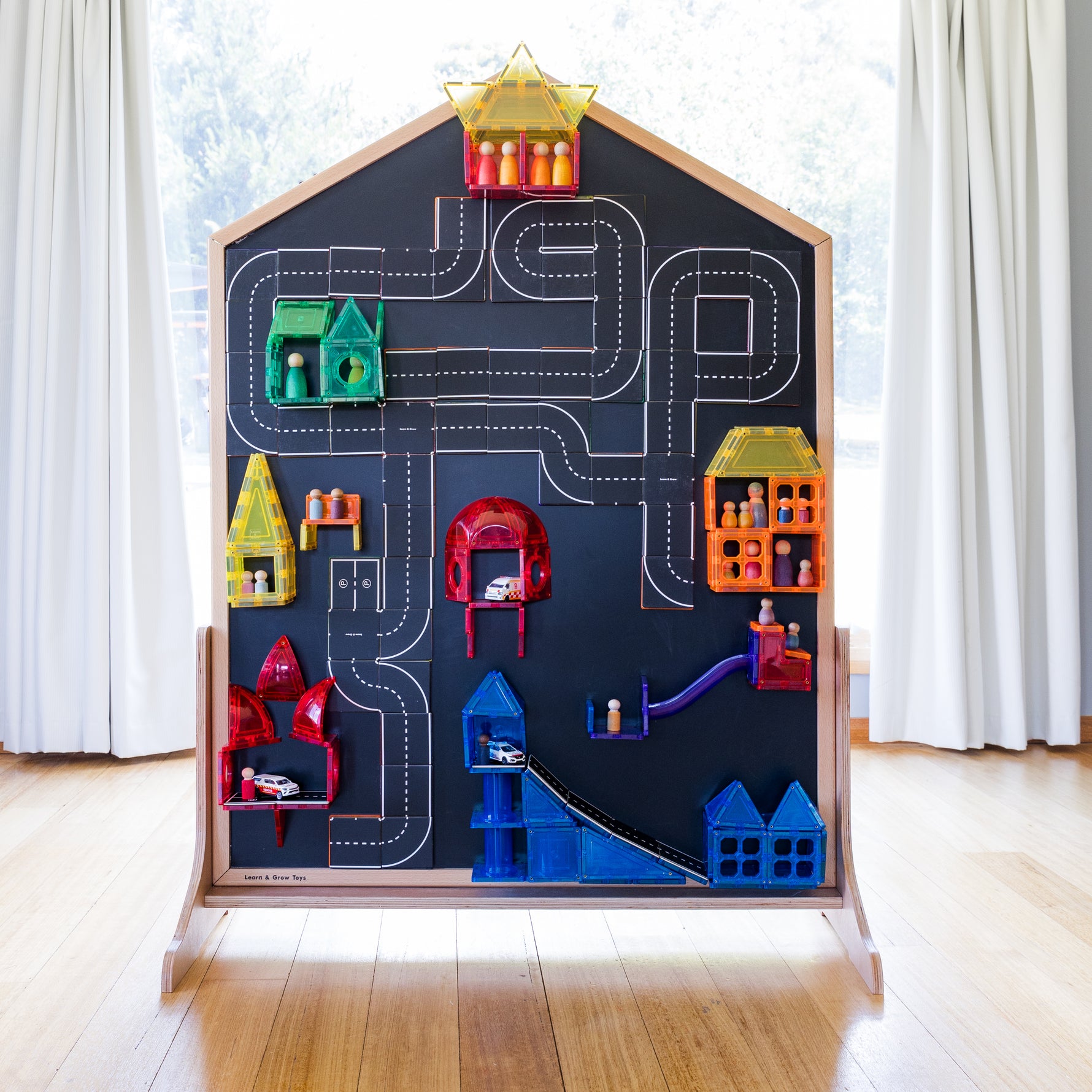 agnetic tiles and road toppers sitting on blackboard of multi-board with stand sitting flush