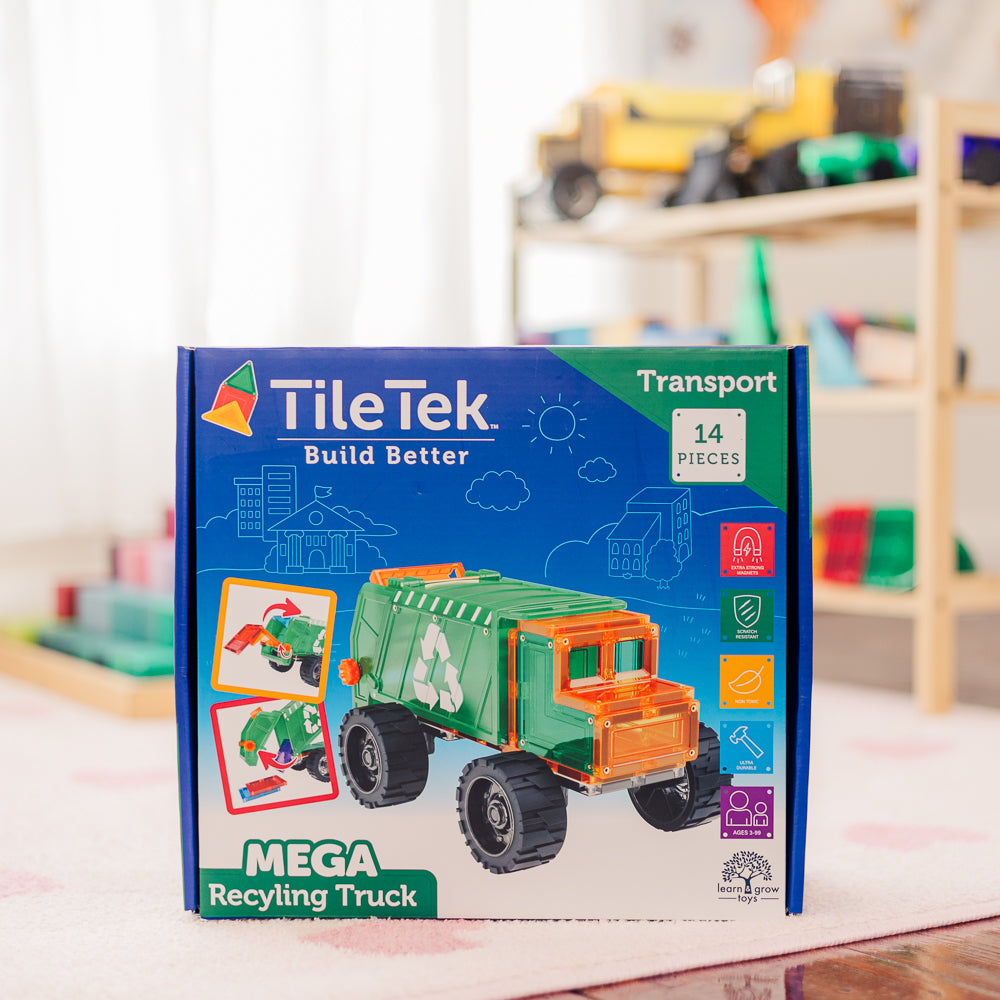 TileTek Mega Recycling Truck toy set packaging on a table with a blurred background of toys.