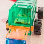 Toy truck with green and orange design on a light background