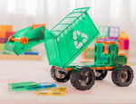 Toy dump truck with a recycling symbol on a light surface