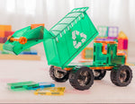 Toy magnetic tile dump truck with a recycling symbol in a playroom