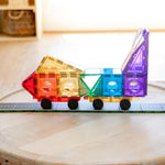 Colourful vehicle made from magnetic tiles sitting on road tile toppers on a table