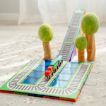 Learn and Grow toys train toppers set up with papoose wooden trees in bright room 