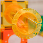 Close-up of a yellow ball run component with a blurred background