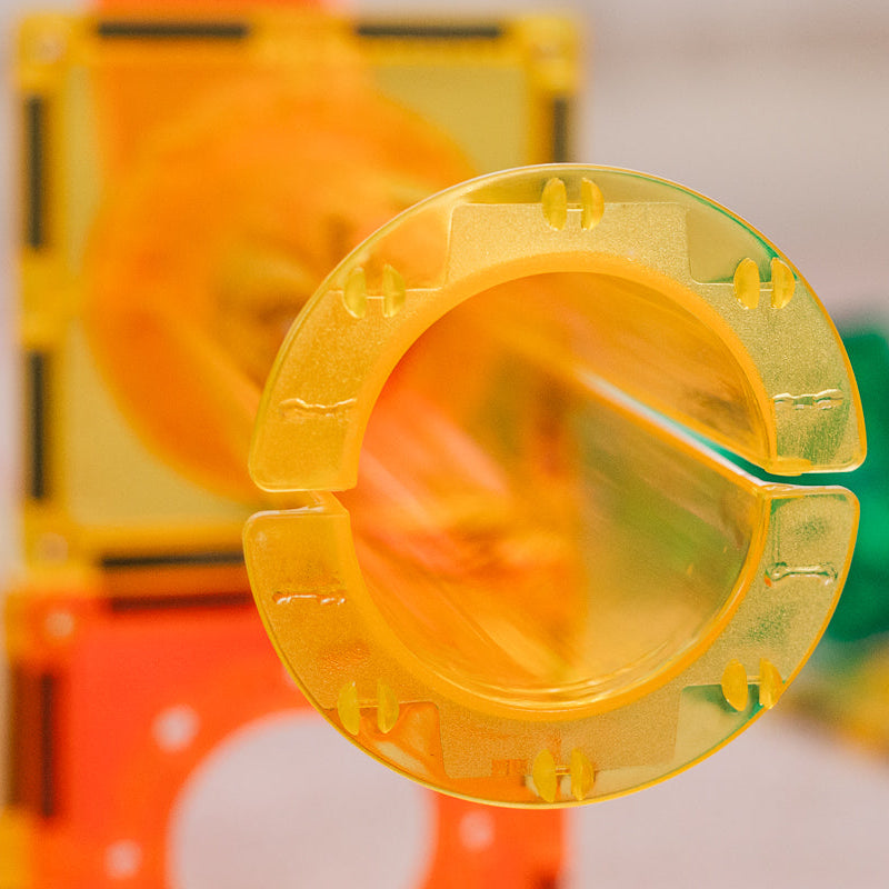 Close-up of a yellow ball run component with a blurred background