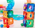 Colourful magnetic building blocks with a bowl and balls on a light background
