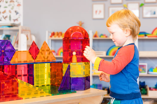 Child playing with 18 pc dome set of magnetic tiles