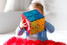 Load image into Gallery viewer, Girl holding a cube of learn and grow magnetic large square tiles in blue, yellow and red
