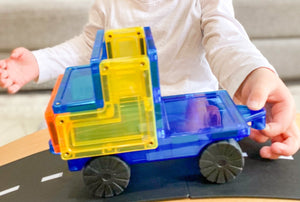Magnetic truck being pushed by a child