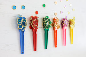 Colourful magnetic wands and metal rimmed counting chips used by children for sensory play