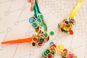Colourful magnetic wands and metal rimmed counting chips used by children for sensory play