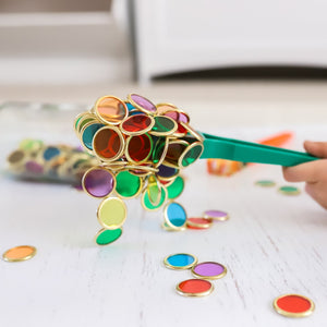 Colourful magnetic wands and metal rimmed counting chips used by children for sensory play